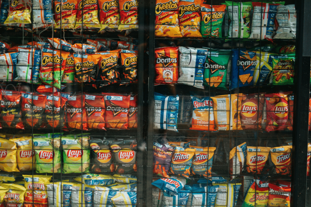 image of various small bags of snacks behind a gated enclosure