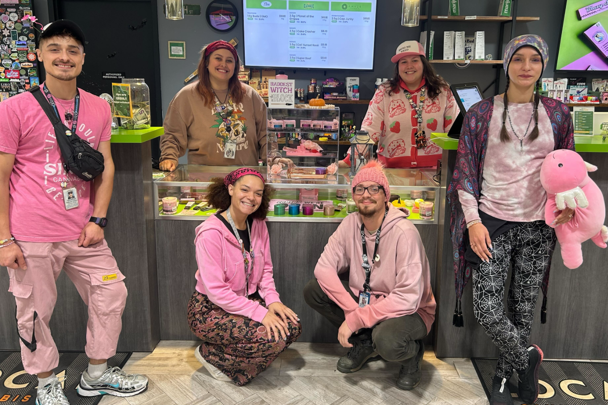 Happy NatureMed employees dressed in pink for a staff event, reflecting the fun and welcoming environment at the Best Dispensary of KC.