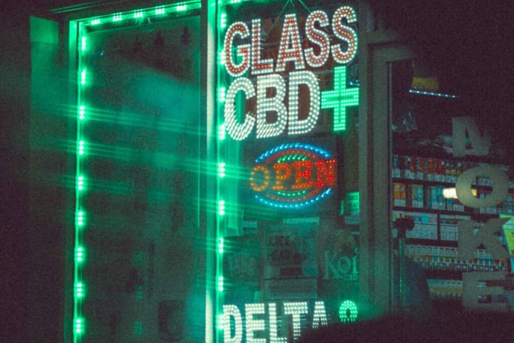 - Nature Med Dispensaries CBD Delta-9 dispensary sign illuminated at night, highlighting hemp product retail market.