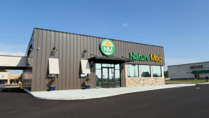 Modern exterior storefront of the new NatureMed location in Paducah, Kentucky, featuring green signage and stone accents at 435 North 32nd St.