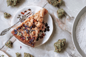 Apple Tartz cannabis nugs served alongside a slice of apple pie topped with edible flowers
